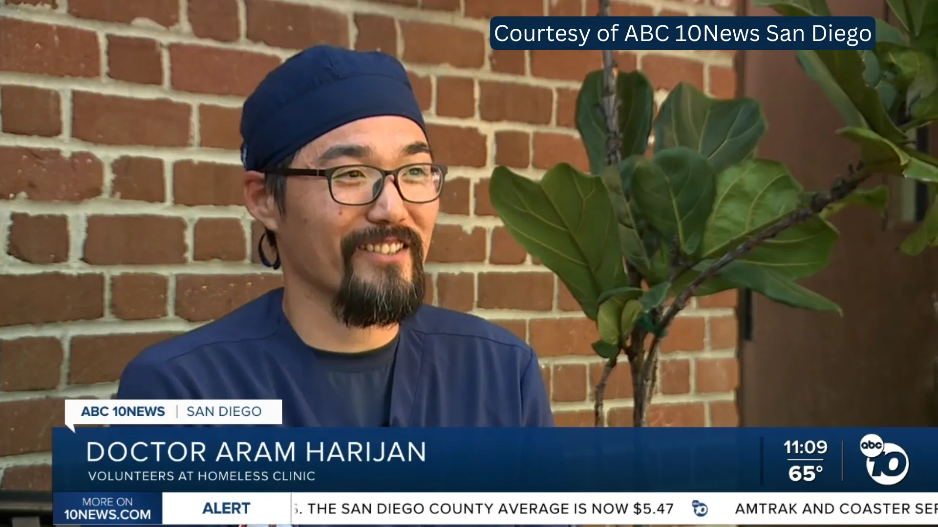 Smiling image Doctor Aram Harijan volunteering at homeless clinic, courtesy of ABC 10News San Diego.