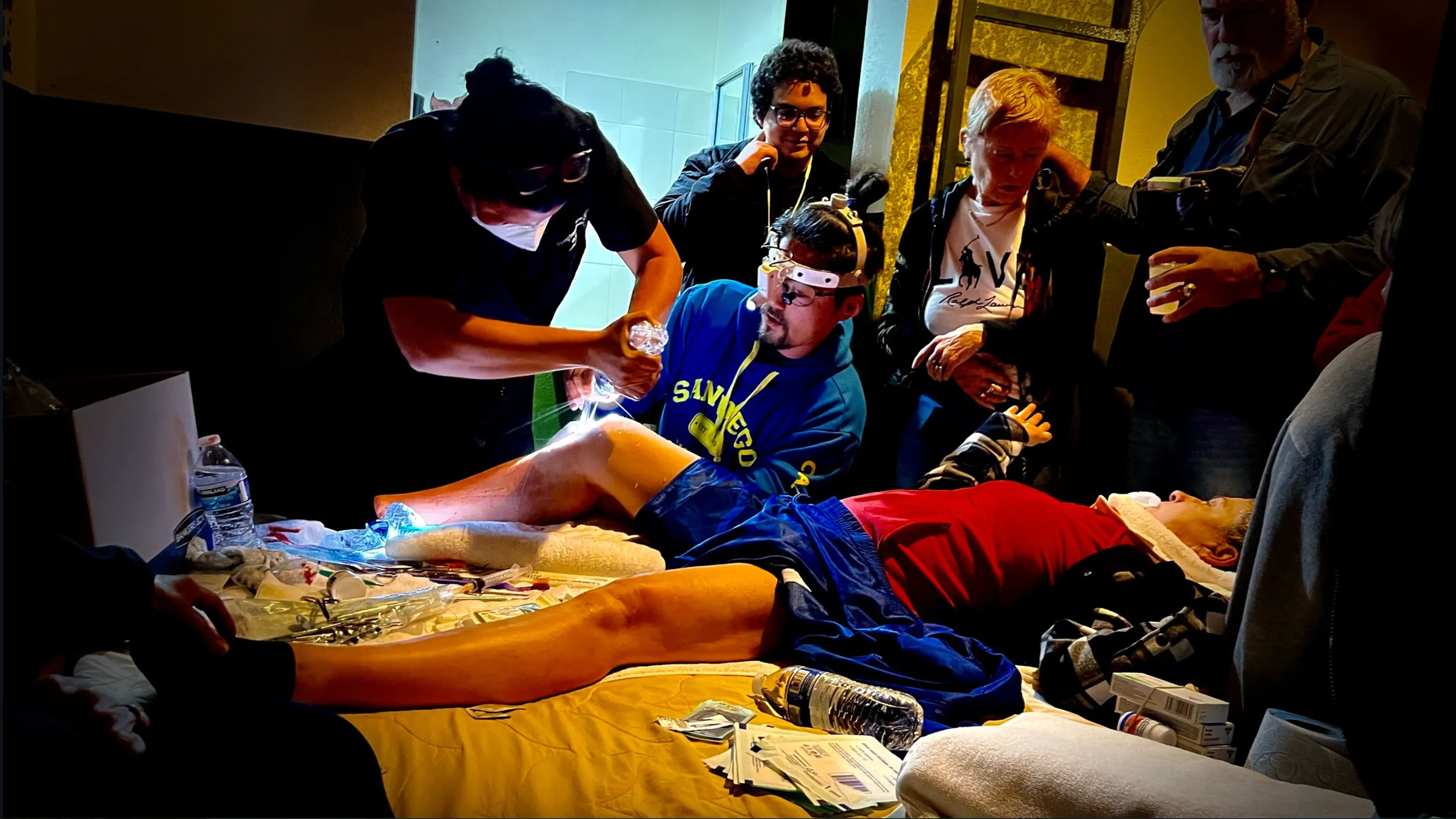 Dr. Harijan performing a medical procedure in Baja California with a team assisting him.